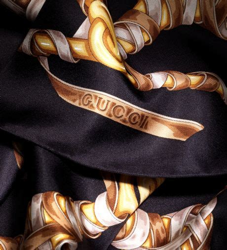 gold and black gucci scarf.